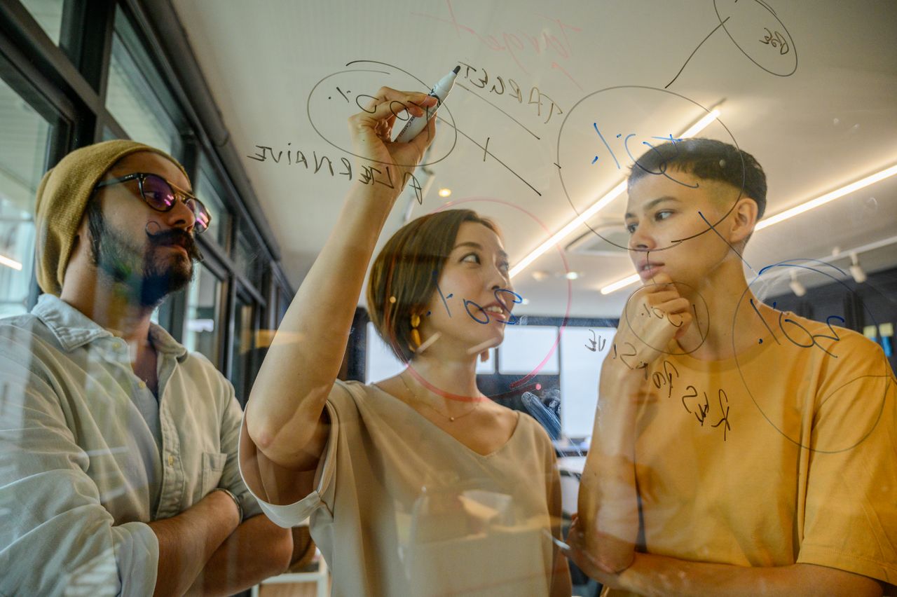 Team brainstorming brand positioning on a glass board