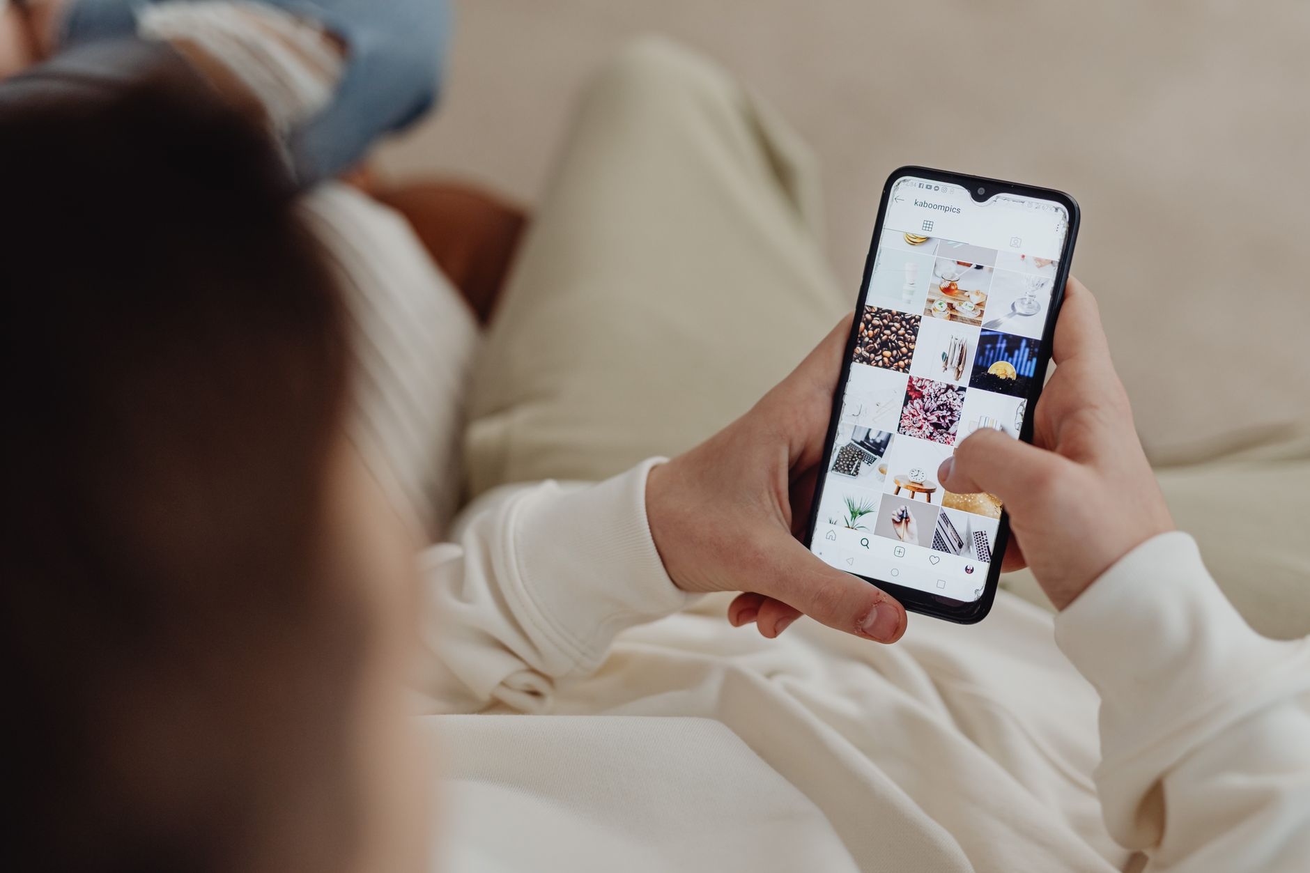 Person browsing a social media feed on a smartphone