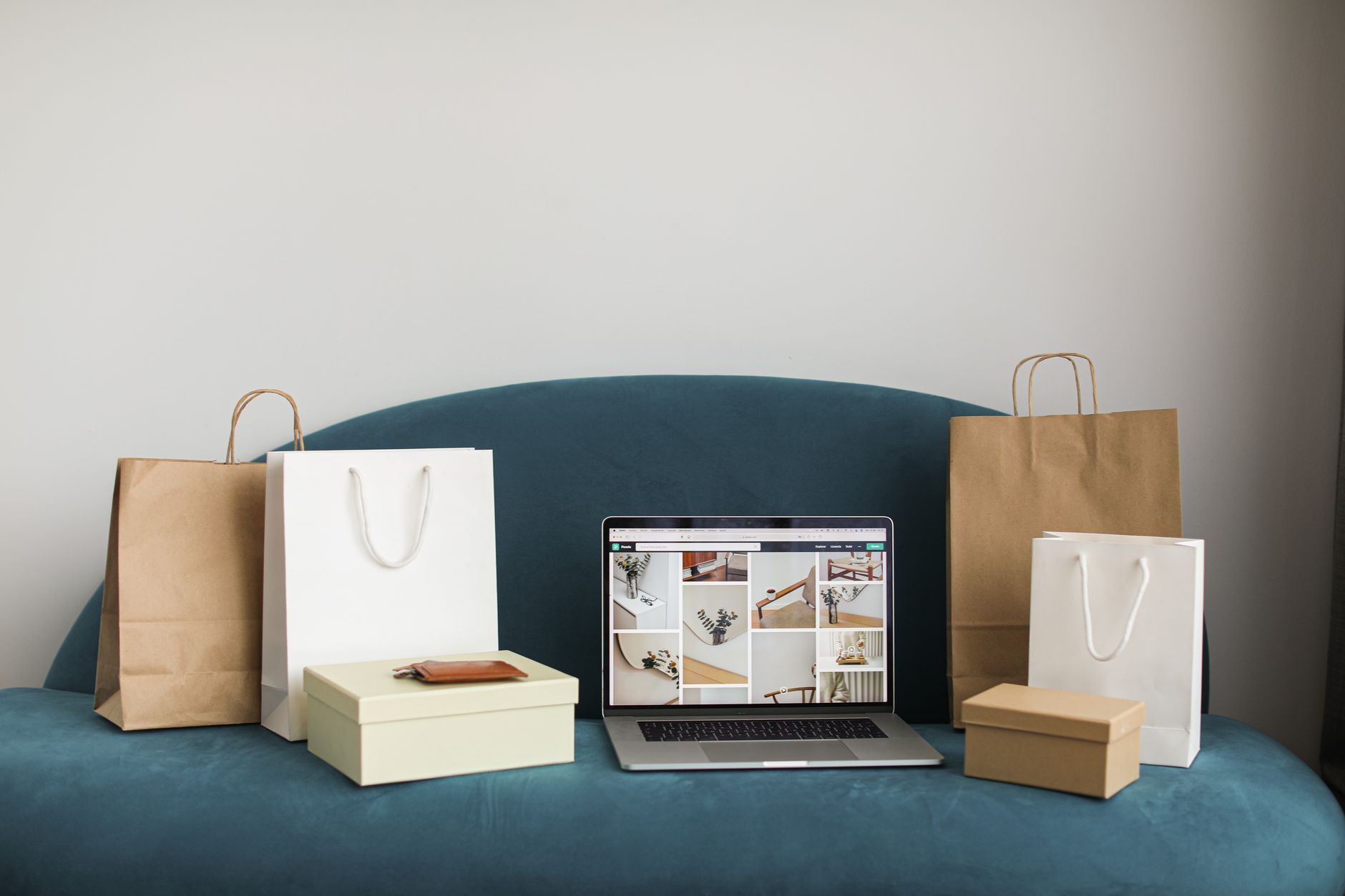 Laptop surrounded by shopping bags and parcels