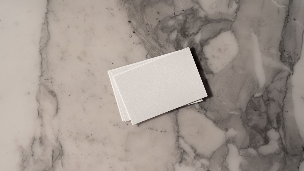 Stack of business cards on a marble surface